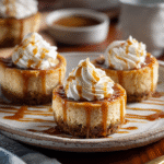 Mini Dulce de Leche Cheesecakes – Creamy, Irresistible, and Easy to Bake 9 Mini dulce de leche cheesecakes with caramel drizzle