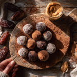 No bake brownie bites on wooden board with cocoa