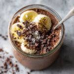 High Protein Chocolate Chia Pudding in a jar with toppings